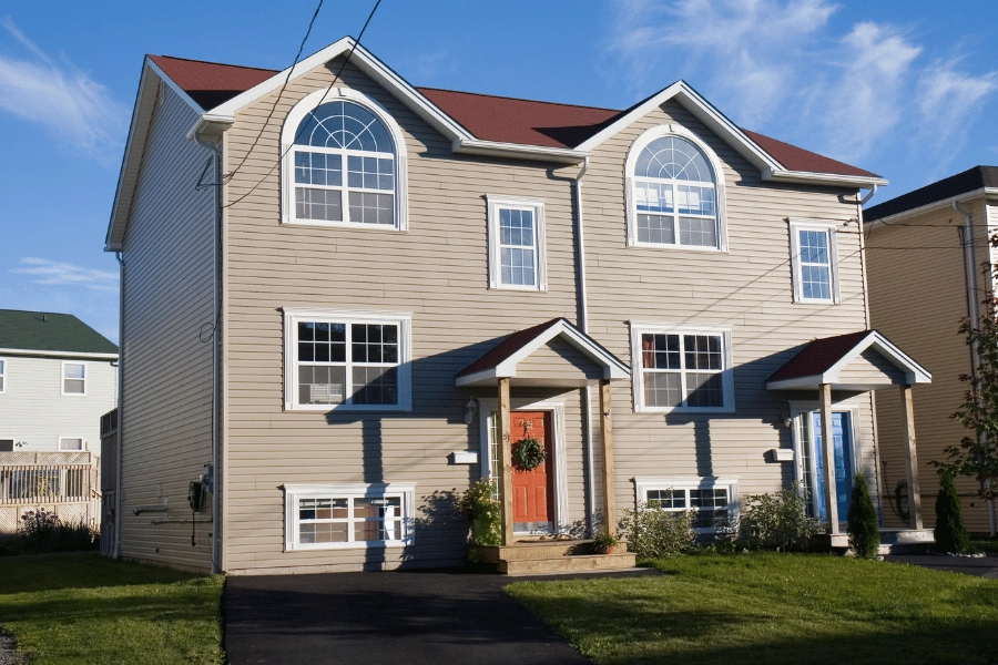 new multi-family home with one red door and blue door and a shared wall